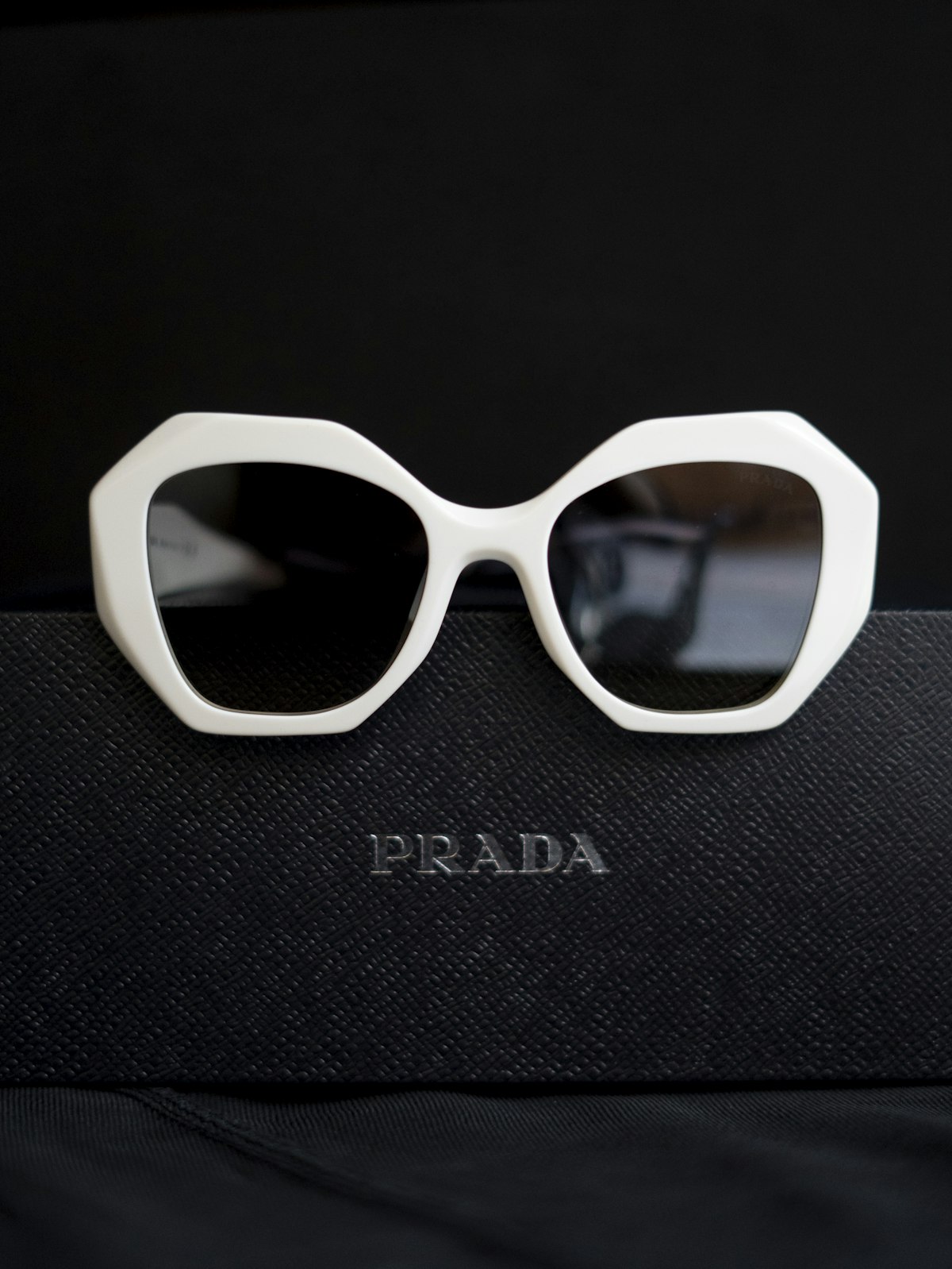 Designer sunglasses displayed on a stand