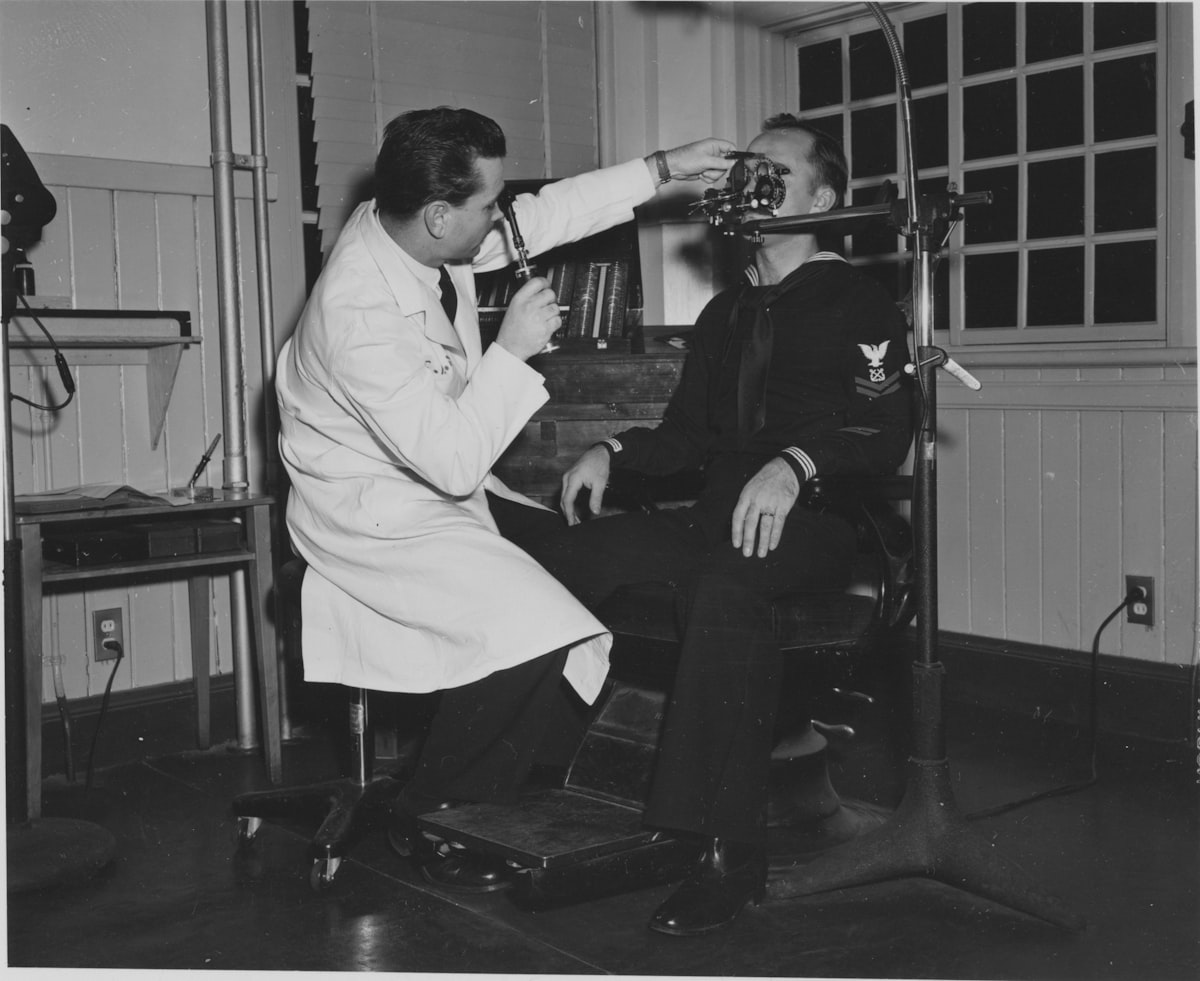 Doctor examining a patient's eyes with equipment
