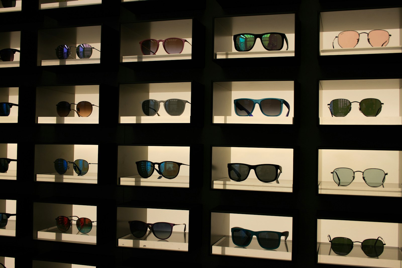 Illuminated display case featuring authentic designer sunglasses and eyeglasses