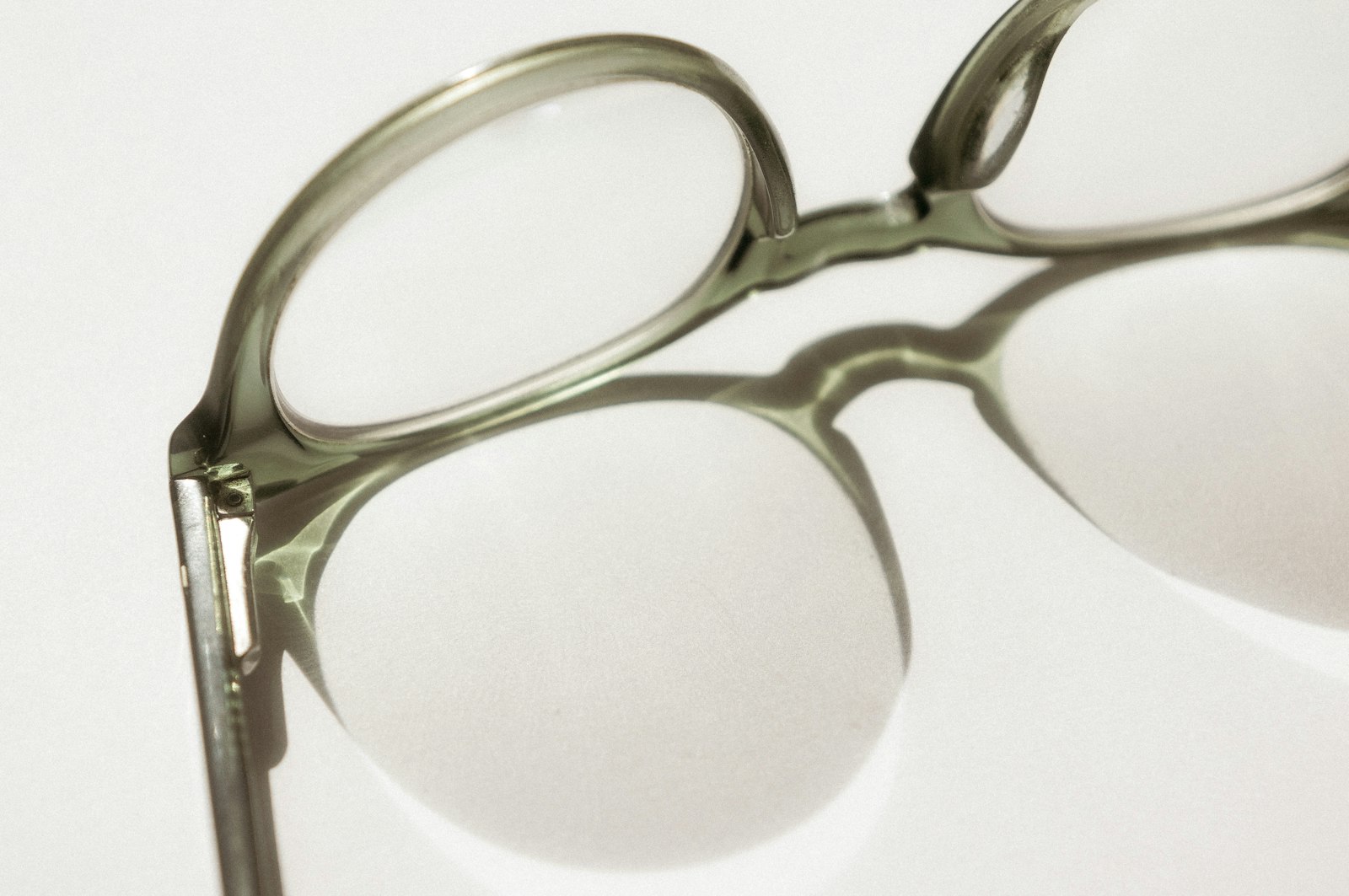 Close-up of eyeglass frame and lens on a white background
