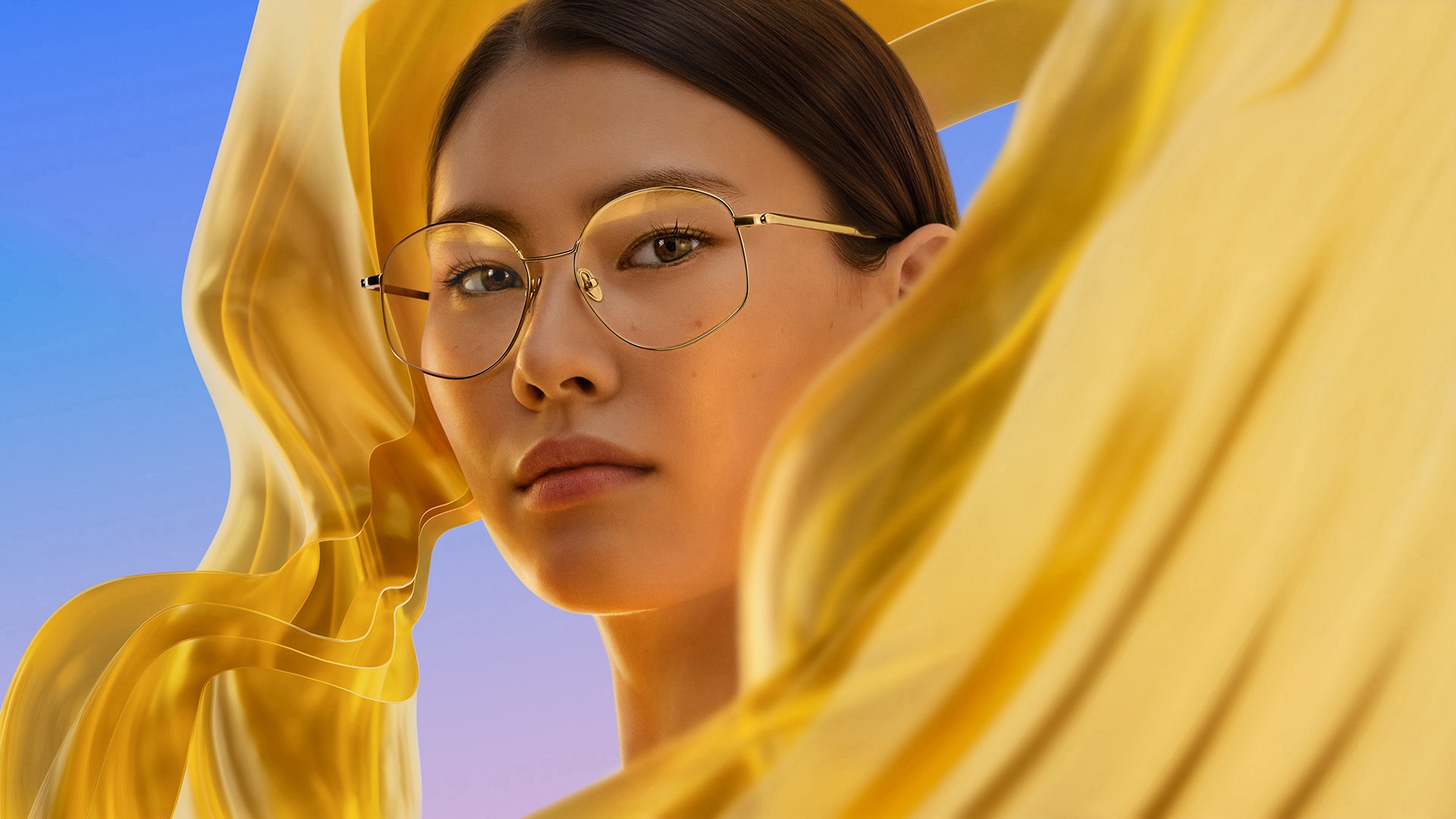 Close-up portrait of a woman wearing glasses, representing a premium anti-reflective lens coating
