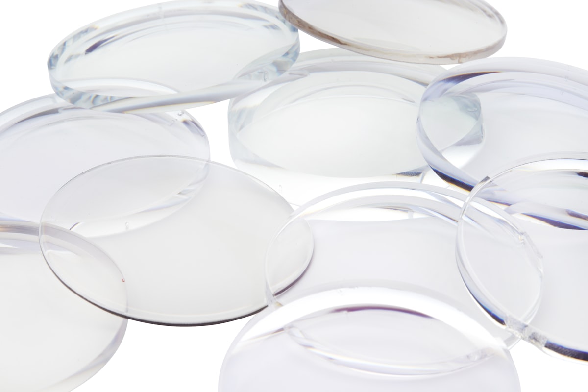 Close-up of round uncut progressive eyeglass lenses on a white background
