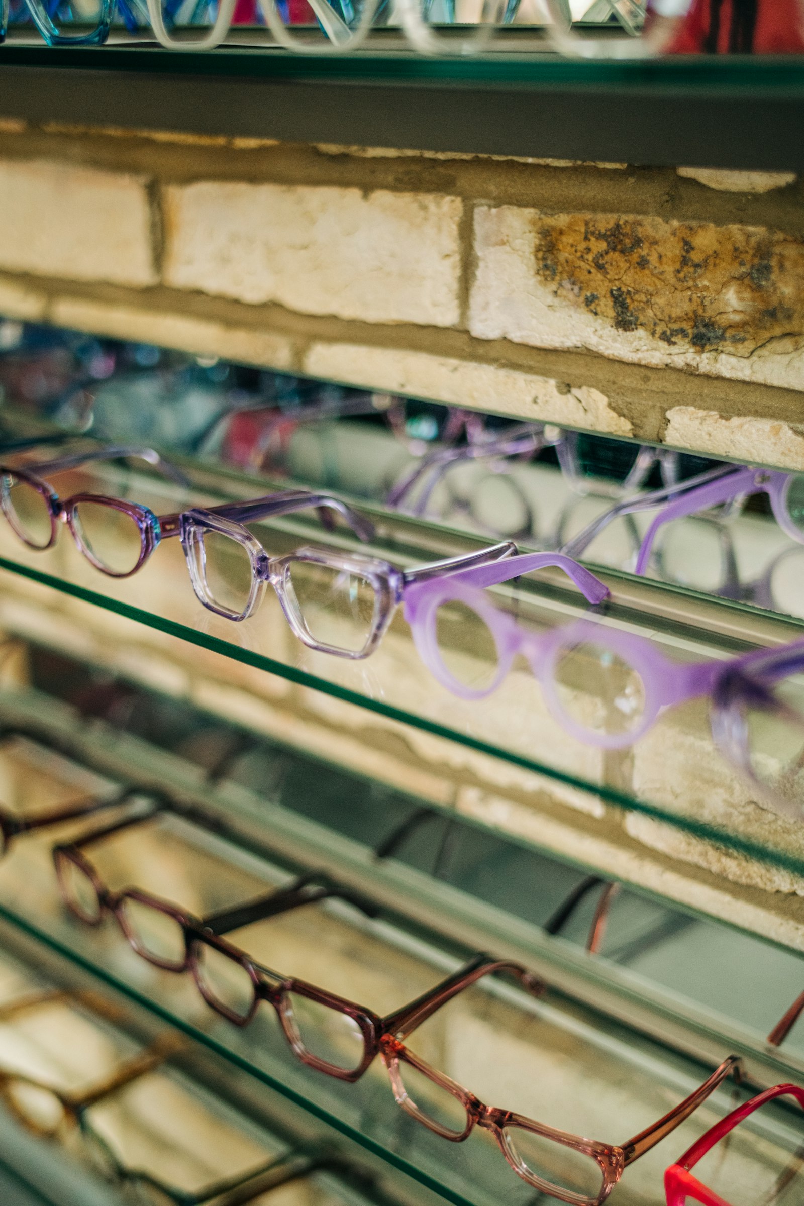 Designer eyeglass frames on display inside the Designer Eyewear Outlet optical store